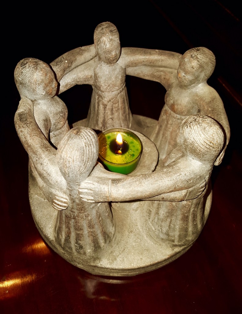 pottery figure of women encircled around candle, www.alvaradofrazier.com